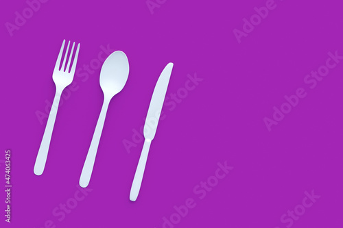 White fork  spoon and knife on violet background. Copy space. Top view. 3d render