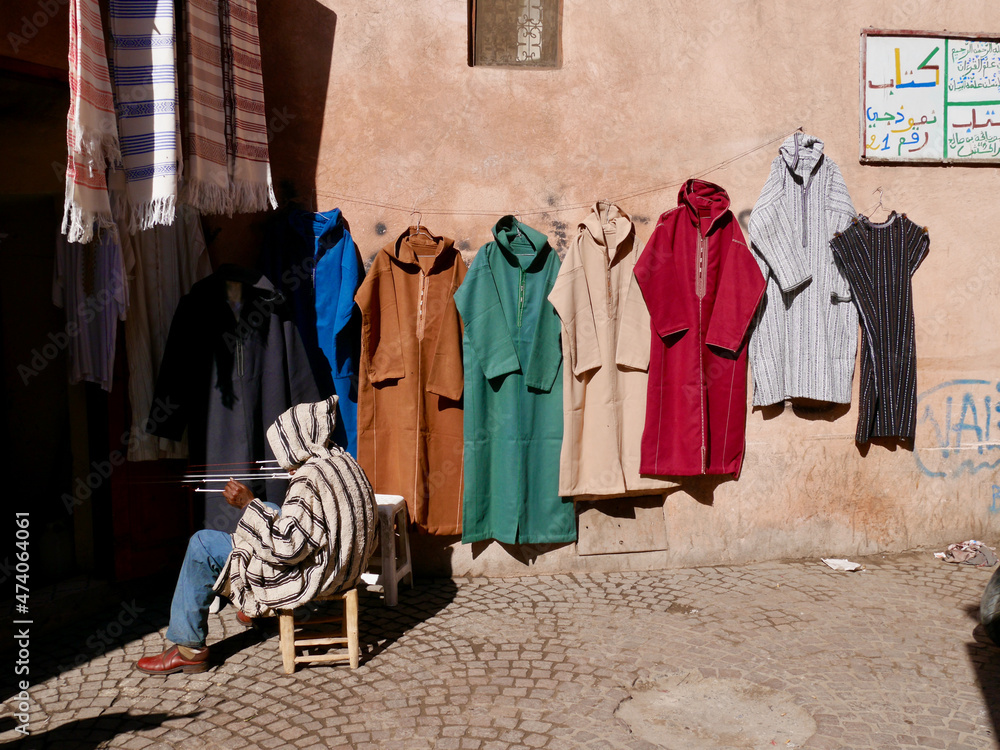 Marrakech, Morocco, 25.01.2020. Man tailoring colorful caftans in the Medina.
