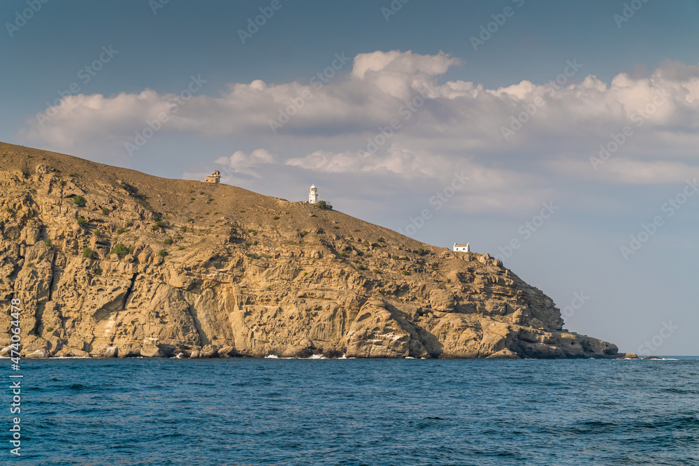The Republic of Crimea. July 21, 2021. View of the lighthouse and buildings on Mount Meganom, which is located near the city of Sudak.