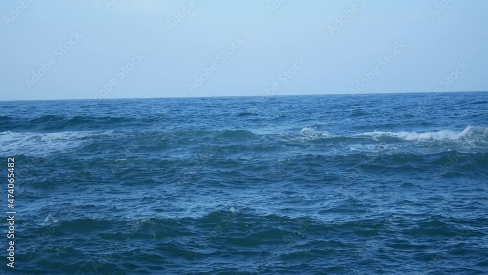 Waves of the Sea Reaching the Shore with Lots of Foam in a Cloudy and Cold Sky Waves of the Sea Reaching the Shore with Lots of Foam in a Cloudy and Cold Sky