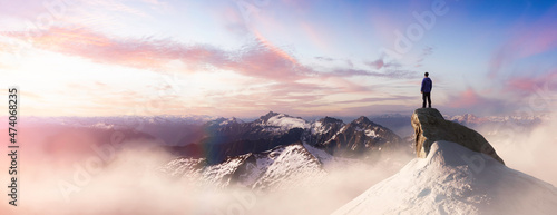 Extreme adventure composite. Man on top of a Rocky Mountain Cliff. Dramatic Sunset. 3d Rendering Peak. Aerial Background Panorama Image from British Columbia, Canada. Adventure Concept Artwork