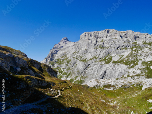 Hiking path through rocky landscape surrounded by Sulzfluh and Scheinfluh in Praettigau, Graubuenden, Switzerland.