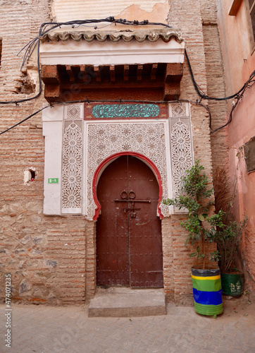 Traditional wooden house door with ornamental decoration in the Medina of Marrakech, Morocco. © Maleo Photography
