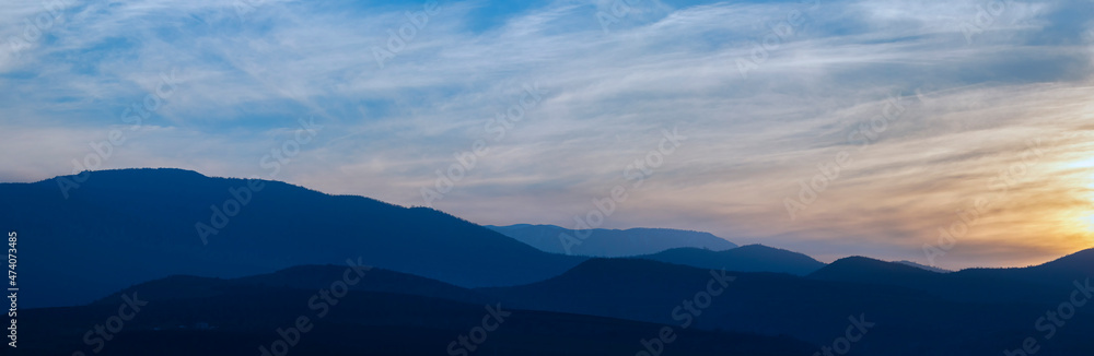 Mountains in a misty haze at sunset