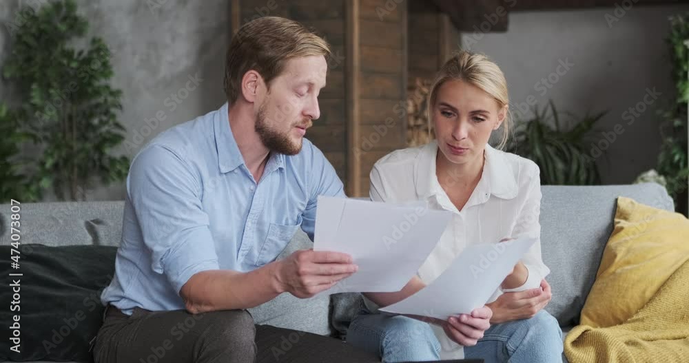 Woman realtor and male client discussing paper document agreement house rent or buying real estate checking information talking price. Business people partners communication contract deal at home