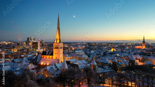 Aerial view to the historic Tallinn old down hall and square with the seasonal Christmas market 