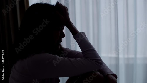 A woman is anxiety and crying in the bedroom.