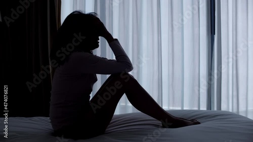 A woman is anxiety and crying in the bedroom.