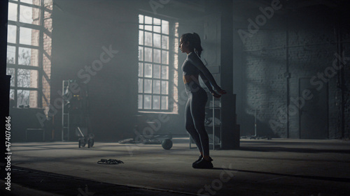 Woman doing lunge squat exercise. Bodybuilder making frontal squats with lunges