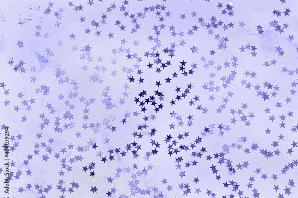 Color of the year 2022 Very Peri. Shiny stars on white and blue background. Winter abstract background in trendy color. New Year party, Christmas celebration, holidays, dreams concept. Selective focus Color of the year 2022 Very Peri. Shiny stars on white and blue background. Winter abstract background in trendy color. New Year party, Christmas celebration, holidays, dreams concept. Selective focus