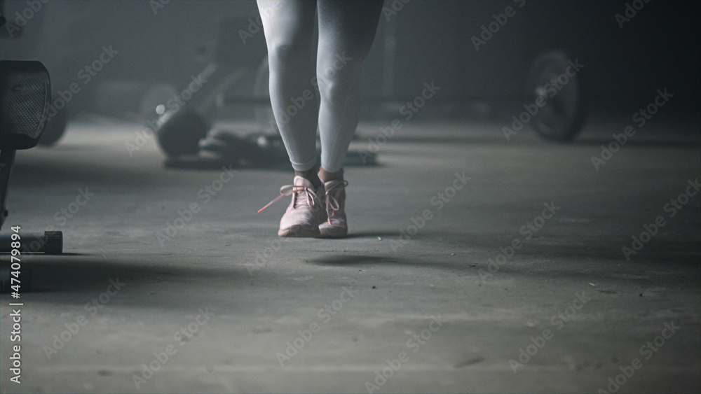 Woman standing on start position. Female jogger legs running in sport club Woman standing on start position. Female jogger legs running in sport club