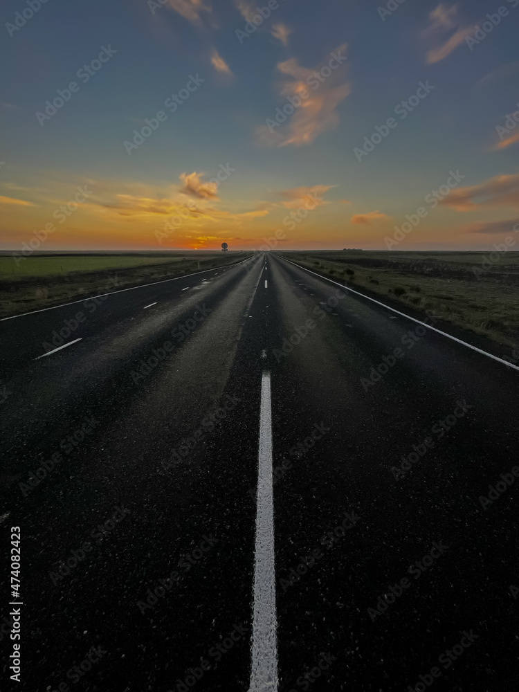 Beautiful look of an infinite road, highway going to a sunset in the Iceland highlands Beautiful look of an infinite road, highway going to a sunset in the Iceland highlands