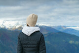 Back view of young woman on top of mountain