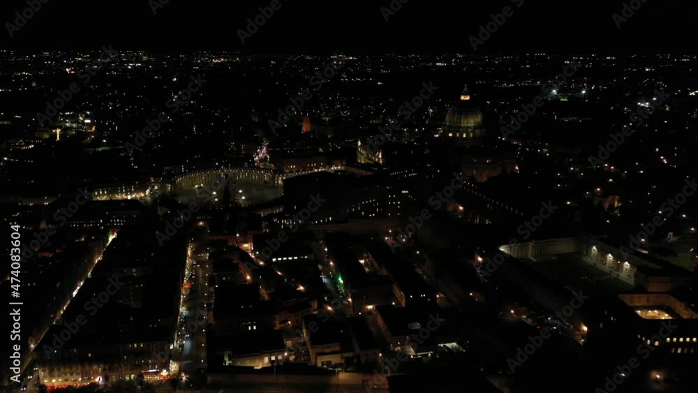 Aerial drone night video of illuminated Saint Peter's square, world's largest church - Basilica of St. Peter's, Vatican - an elliptical esplanade created in the mid seventeenth century, Rome, Italy Aerial drone night video of illuminated Saint Peter's square, world's largest church - Basilica of St. Peter's, Vatican - an elliptical esplanade created in the mid seventeenth century, Rome, Italy