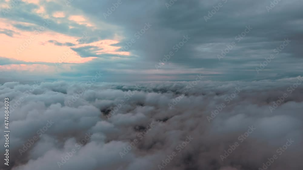 Aerial view from airplane window at high altitude of earth covered with puffy cumulus clouds forming before rainstorm Aerial view from airplane window at high altitude of earth covered with puffy cumulus clouds forming before rainstorm