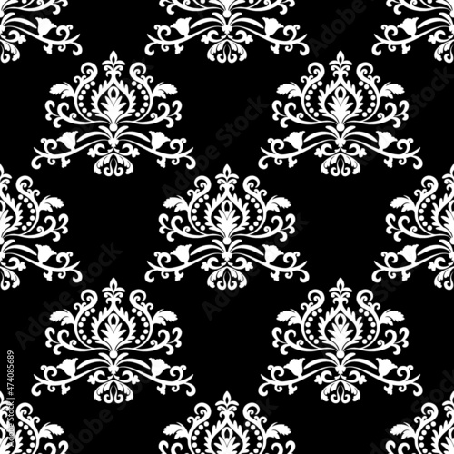Oriental vector pattern with white arabesques on black background. Floral wallpaper.  Vintage lace seamless pattern. For fabric, wallpaper, tiles or packaging.