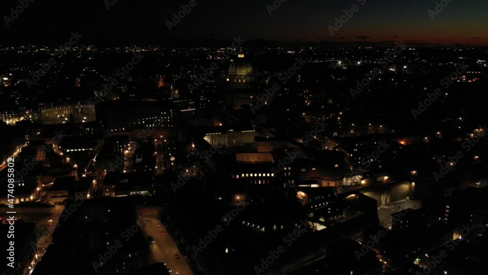 Aerial drone night video of illuminated Saint Peter's square, world's largest church - Basilica of St. Peter's, Vatican - an elliptical esplanade created in the mid seventeenth century, Rome, Italy Aerial drone night video of illuminated Saint Peter's square, world's largest church - Basilica of St. Peter's, Vatican - an elliptical esplanade created in the mid seventeenth century, Rome, Italy
