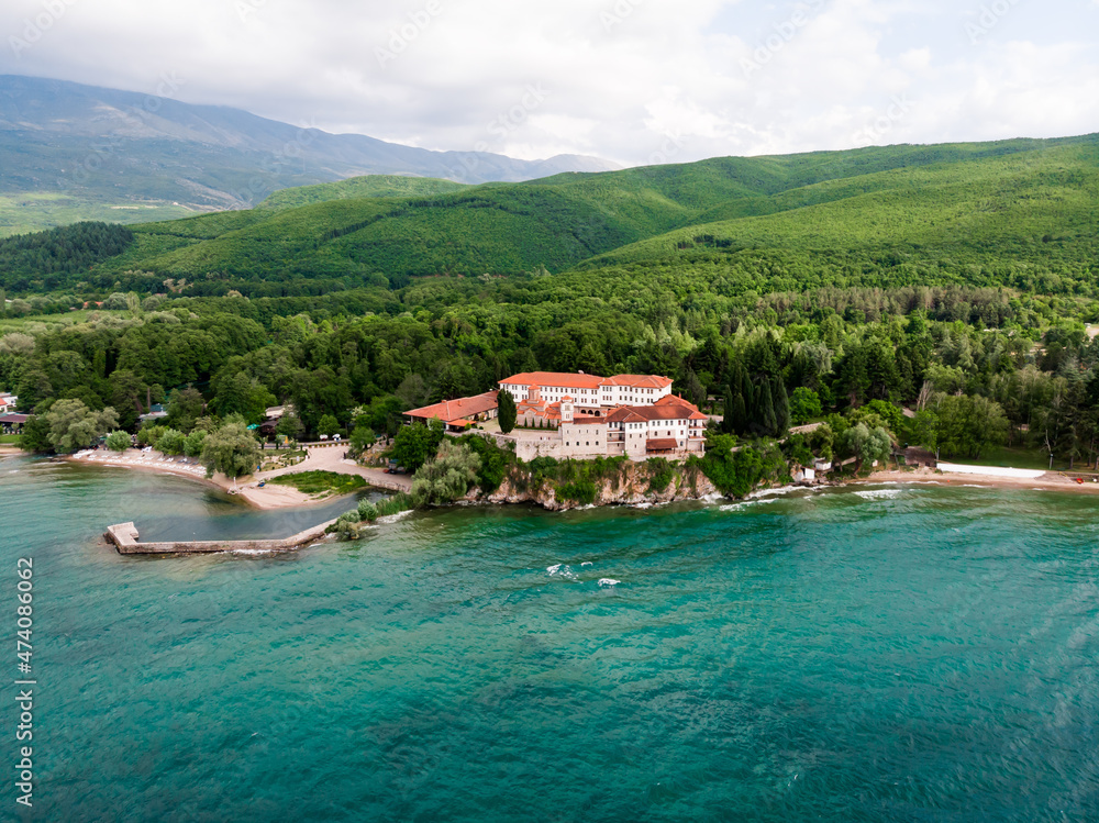 Drone shot of the monastery of St. Naum. An Orthodox monastery in North Macedonia drone view. Monastery of St. Naum on a hill near Lake Ohrid. Green hilly mountains in Macedonia.