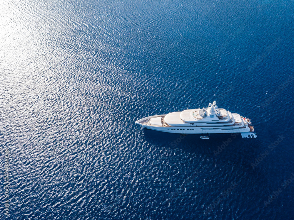 Naklejka premium Aerial view on white yacht in blue sea