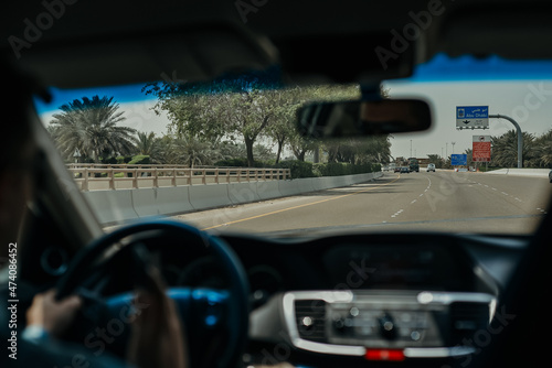 Driving a Car on the Abu Dhabi Road Highway with Dashboard Speedometer in Front of the Steering Wheel 