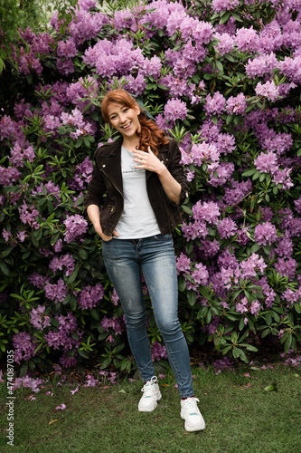 a girl with a unique appearance is in the lilac park. portrait of a girl with spring flowers. March 8. women's Day. girl on a background of flowers