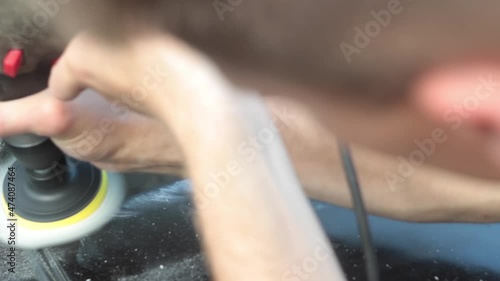 man polishing a black car