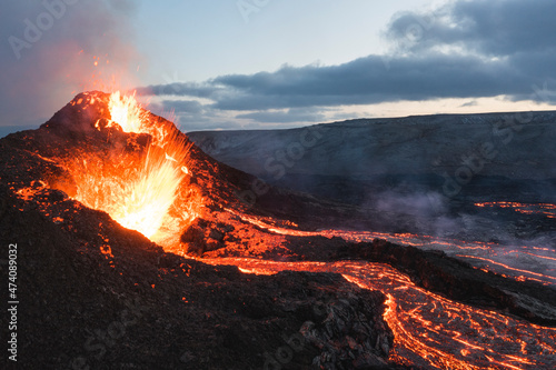 incandescent flowing volcanic lava and caldera in long expo