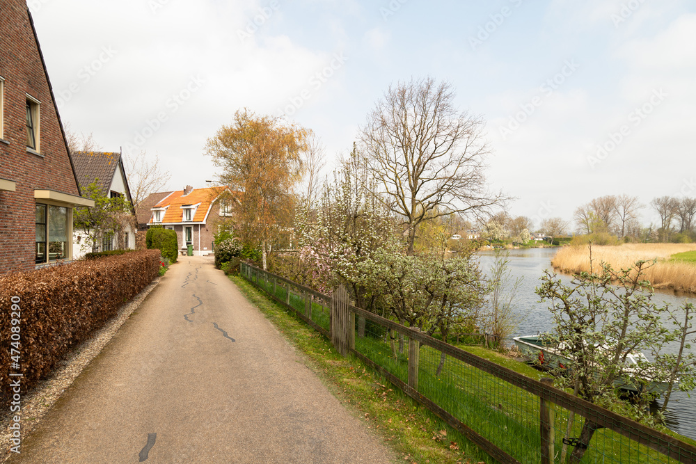 Small houses on the dike in the small village of Acquoy on the river Linge in the Betuwe. Small houses on the dike in the small village of Acquoy on the river Linge in the Betuwe.