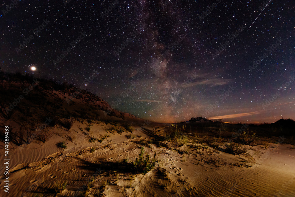 The sandy desert landscape at starry night