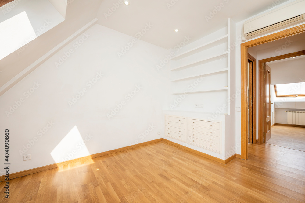 Living room with plaster cabinet with wooden shelves and drawers with oak parquet floors Living room with plaster cabinet with wooden shelves and drawers with oak parquet floors