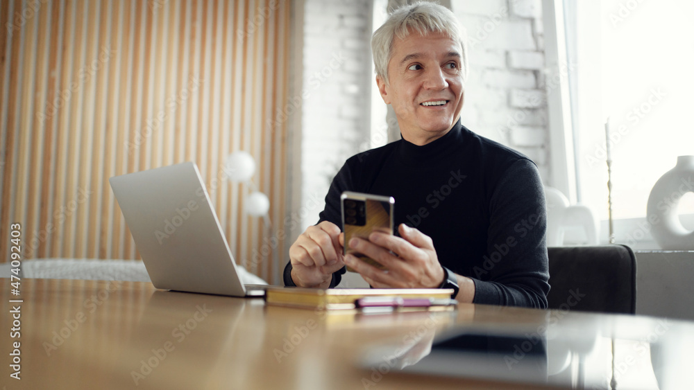 Male freelancer age gray workplace in the office. Works on the Internet on an online site. Male freelancer age gray workplace in the office. Works on the Internet on an online site.