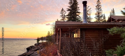 Cozy Log Cabin Near Water at Sunrise or Sunset; Travel and Vacation Ideas