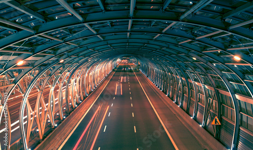 Фотография long exposure of road traffic in the tunnel from the highway