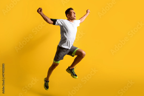 Sporty male runner on color...