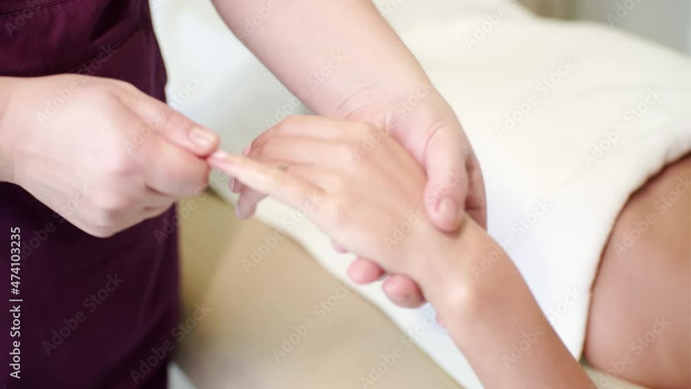 Woman getting relaxation hand massage in spa salon Woman getting relaxation hand massage in spa salon