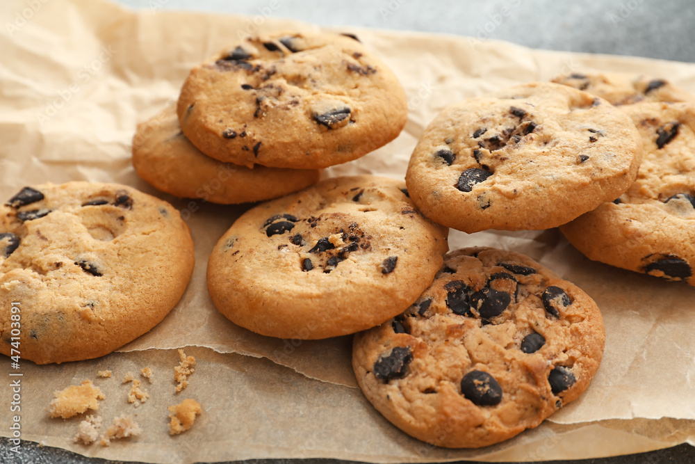 Parchment with tasty homemade cookies on table, closeup Parchment with tasty homemade cookies on table, closeup