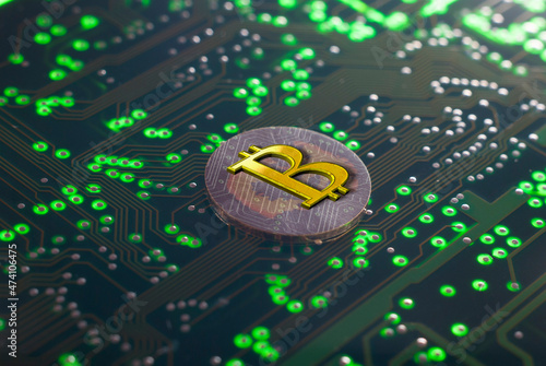 Bitcoin sign on green circuit board