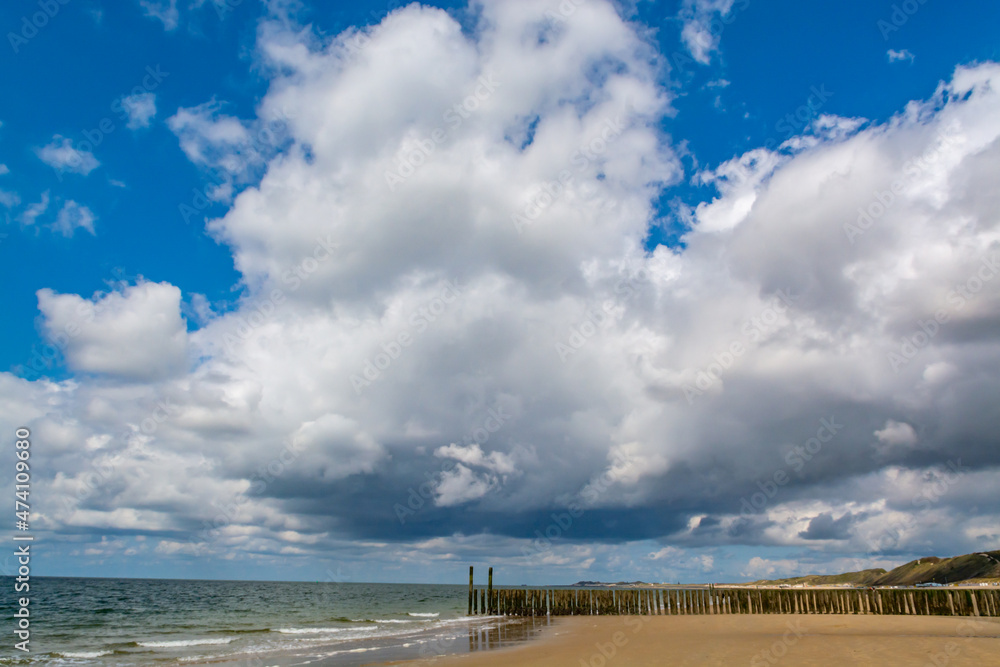 Walking on white sandy North sea beach near Zoutelande, Zeeland, Netherlands before thunderstorm