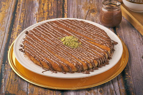 Arabian Traditional Desserts - Cream and cheeses with chocolate and pistachio nuts on top