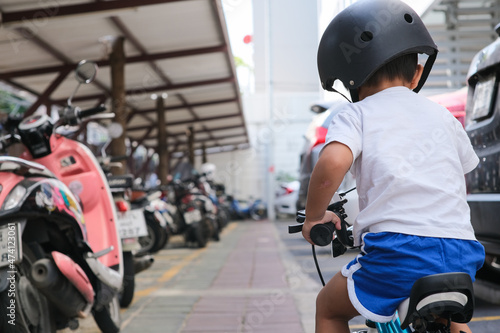 Preschool boy learn to rude bicycle wear helmet