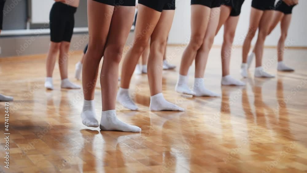 Group of young girls practice fit and light athletic exercises indoors Group of young girls practice fit and light athletic exercises indoors