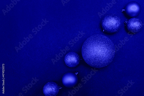 Discreet christmas background, blue christmas balls on blue background