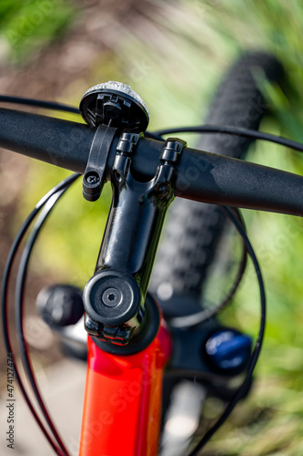 Red Mountain Bike Handlebar Retainer Lever with White Reflector and Front Fork Shock Absorbers © vit