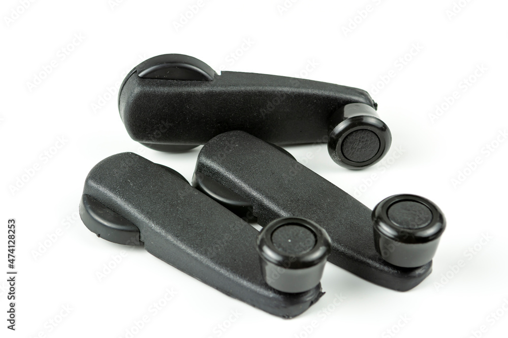 Plastic handle for opening the car window. Spare parts for repair. White background Plastic handle for opening the car window. Spare parts for repair. White background