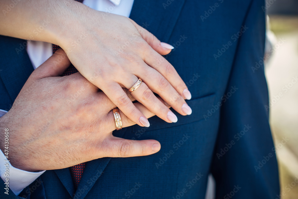 Hands of the bride and groom with gold rings, close-up. Embrace of newlyweds. Creating a loyal family. Hands of the bride and groom with gold rings, close-up. Embrace of newlyweds. Creating a loyal family.