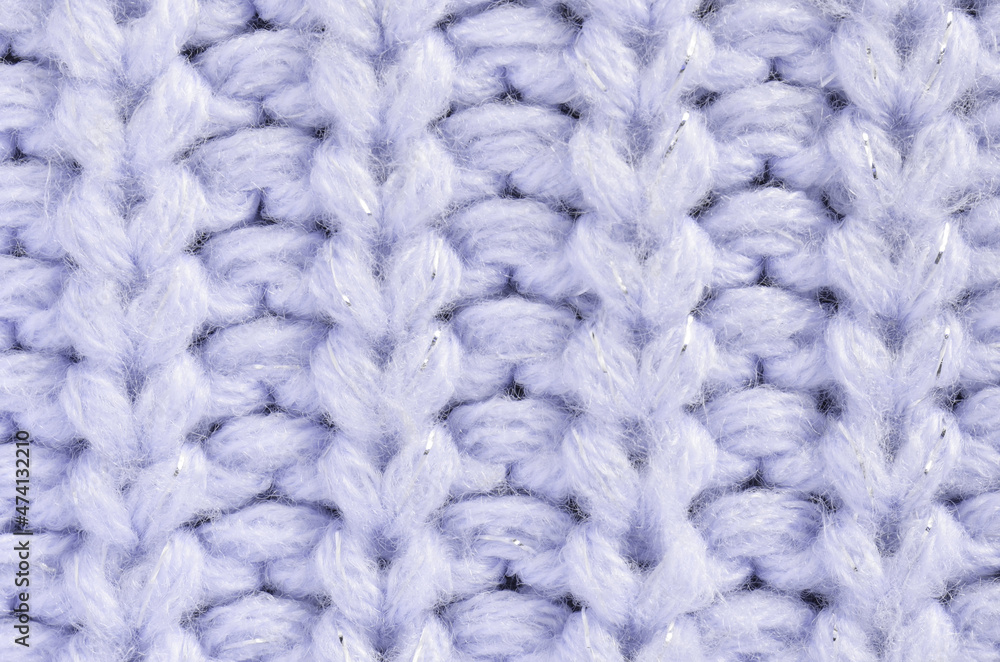 The texture of a knitted sweater. Close-up loops