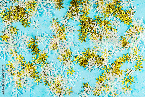 christmas blue background with white and gold large and small snowflakes