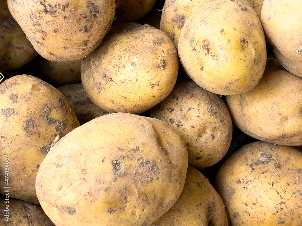 Potatoes stacked on the counter in the marketplace Potatoes stacked on the counter in the marketplace