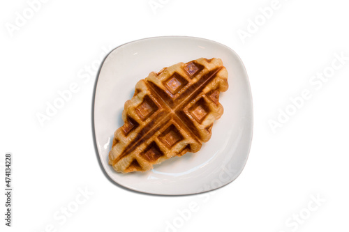 Croffle is a combination of croissant and waffle. This croffle served on a white plate 