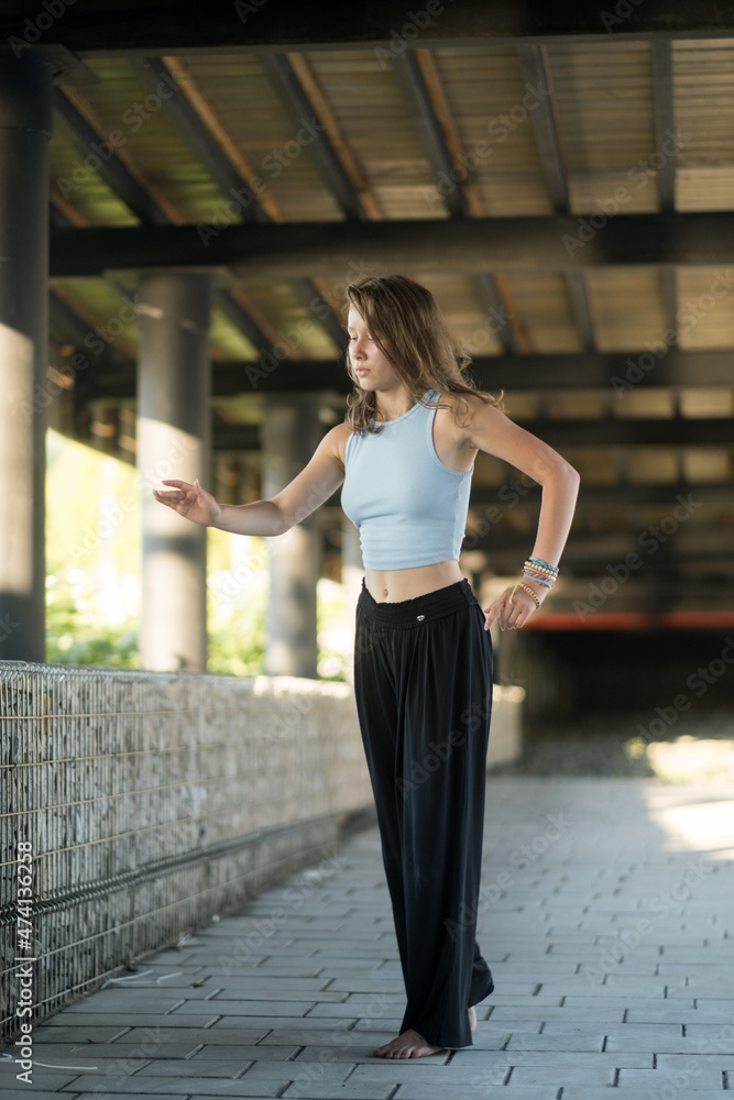 The girl dances beautifully under the bridge The girl dances beautifully under the bridge